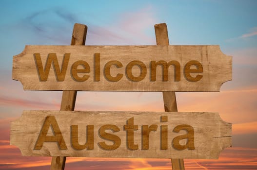 welcome to austria sing on wood background