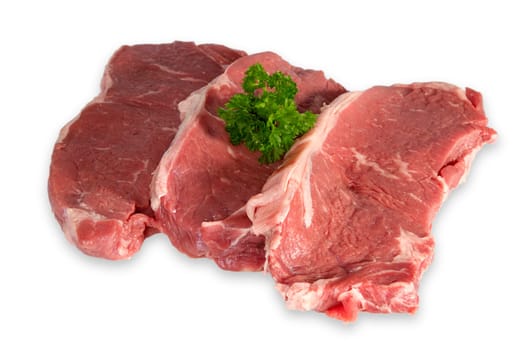 Beef steaks with parsley exposed on a white background