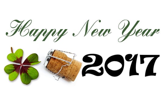 Happy New Year lettering with cloverleaf and champagne corks on a white background