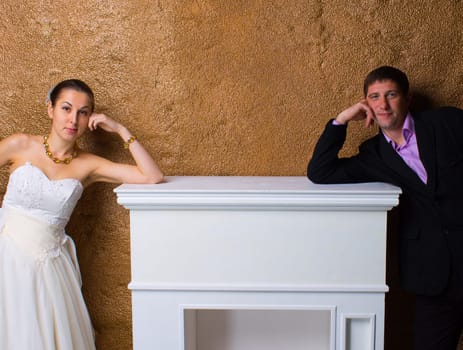 Bride and groom posing together on bronze background