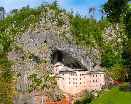 Postojna, Slovenia - May 9, 2014: View of the Predjama Castle, a renaissance castle partly built within a cave mouth and now serves as a famous tourist destination in Postojna, Slovenia.