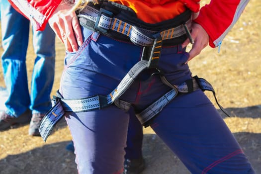The woman is ready to belay a climber