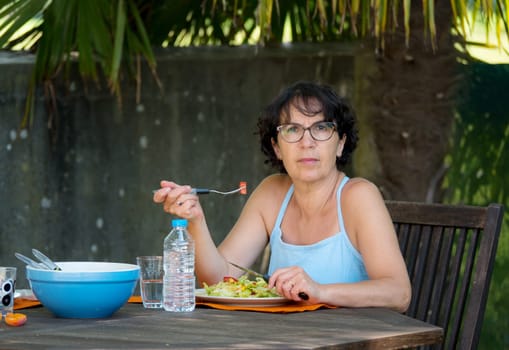 a mature woman lunch in the garden