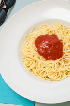 Delicious spaghetti with tomato sauce bolognese on a white plate