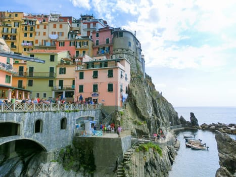 Manarola, Cinque Terre, Italy - September 09, 2015: Colorful traditional houses on a rock over Mediterranean sea at Manarola, Cinque Terre, Italy