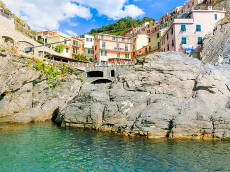 Manarola, Cinque Terre, Italy - September 09, 2015: Colorful traditional houses on a rock over Mediterranean sea at Manarola, Cinque Terre, Italy