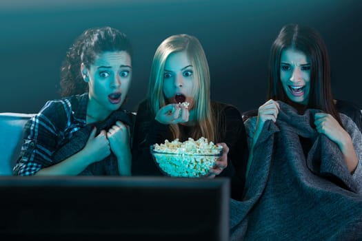 Girls watching 3D movies with popcorn