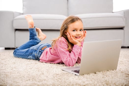 Cute little girl at home studying