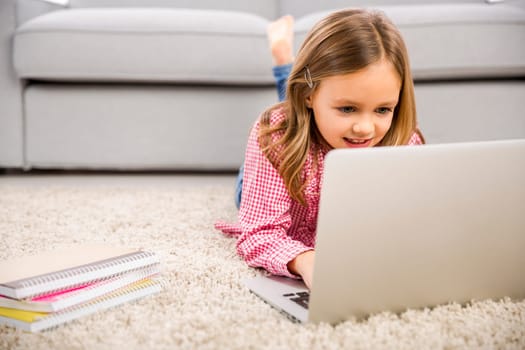Cute little girl at home studying