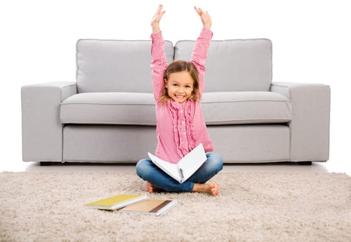 Cute little girl at home studying