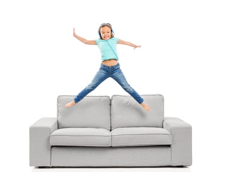 Cute blonde girl jumping and listen music