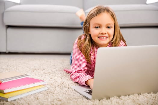 Cute little girl at home studying