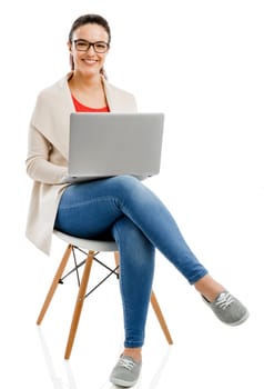 Beautiful and happy woman working with a laptop, isolated over white background