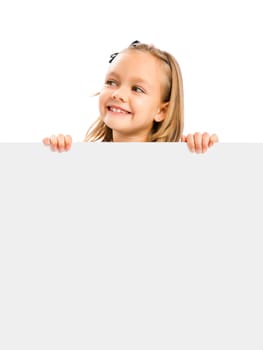 Beautiful little girl holding and showing something on a whiteboard