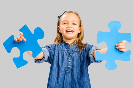 Happy little girl holding a object card