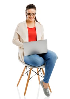 Beautiful and happy woman working with a laptop, isolated over white background