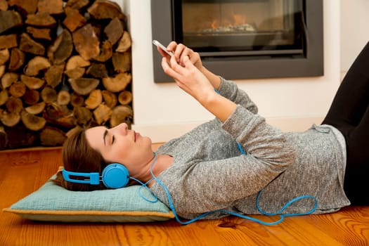 Beautiful woman at home sending text messages