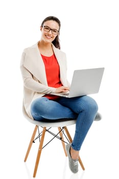 Beautiful and happy woman working with a laptop, isolated over white background