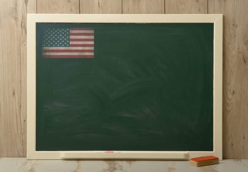 School board on wooden background with American flag