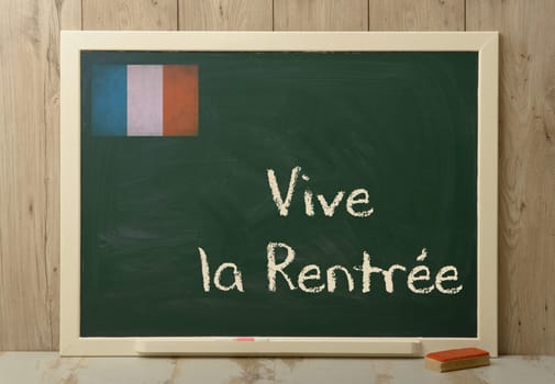 "vive la rentree"" back to school written on green blackboard"