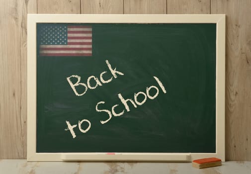 back to school written on a green blackboard
