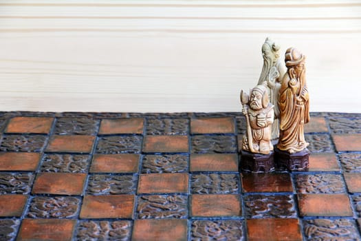 Three chess pieces on a chessboard. Together and cohesion in the game and in life