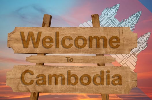welcome to cambodia sing on wood background with blending national flag