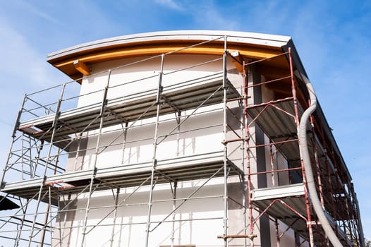 House under renovation with the scaffolding for bricklayers