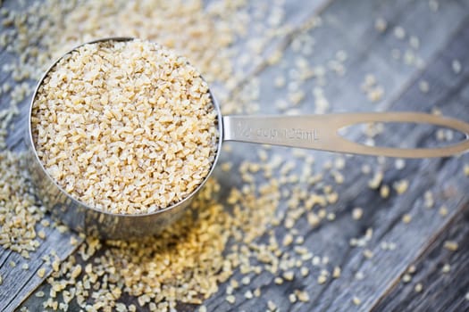 Half cup of raw bulgur wheat ready for recipe.