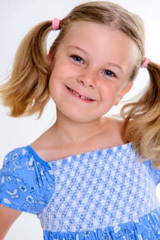 portrait of a little smiling girl with pigtails