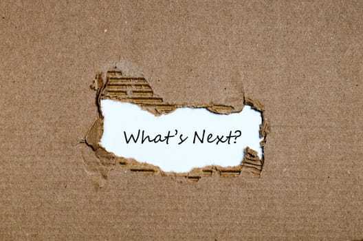 The words what's next appearing behind torn paper