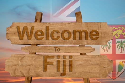 welcome to fiji sing on wood background with blending national flag