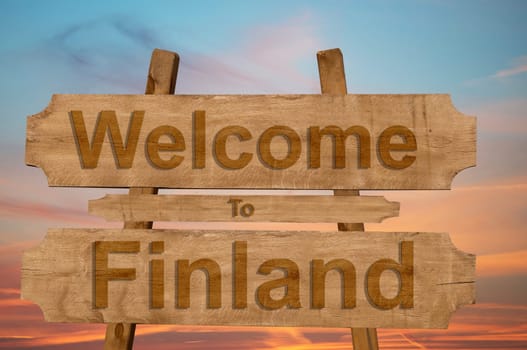 welcome to finland sing on wood background