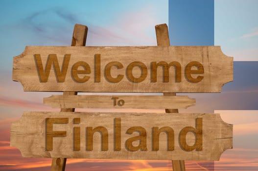 welcome to finland sing on wood background with blending national flag