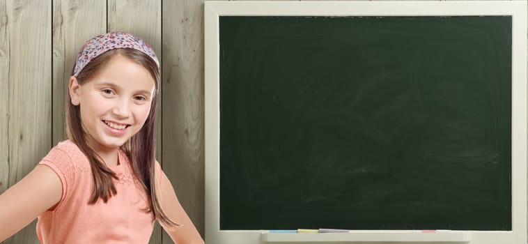 a pretty young girl and a green blackboard
