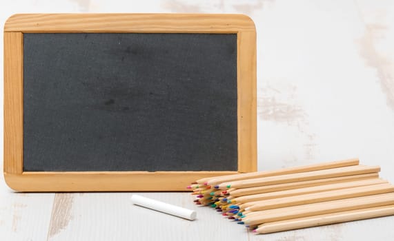 small chalkboard and colouring pencils