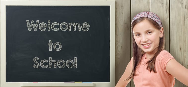 welcome to school written on  blackboard with pretty young girl