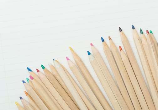 many colored pencils on white paper