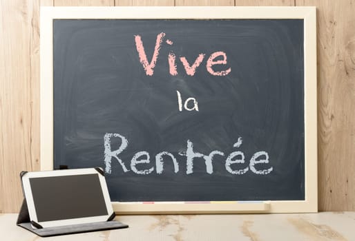 " vive la rentree"" back to school written on  blackboard and tablet"
