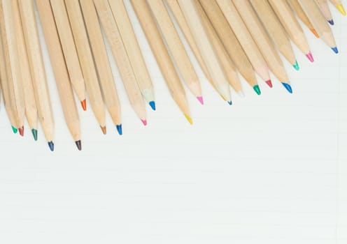 many colored pencils on white paper