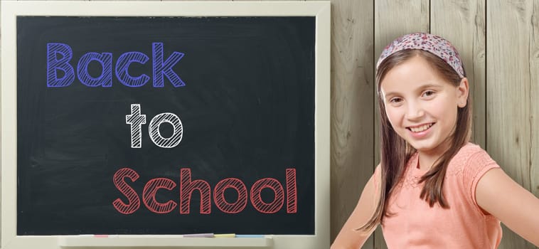 back to school written on  blackboard with pretty young girl