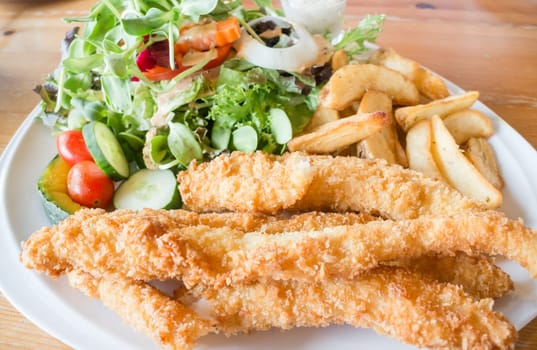 Gourmet fish and chips with salad, stock photo