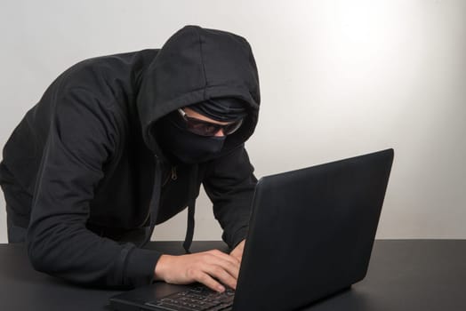 hacker with a hood and black goggles