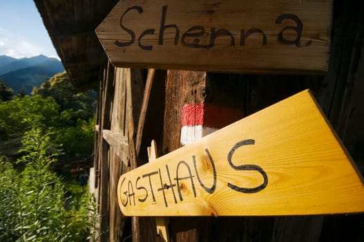 Signpost to the village of Schenna and to a restaurant at a small wooden hut above Merano / South Tyrol