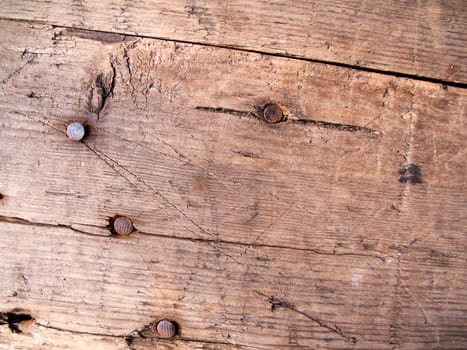 Detailed view of a brown board with nails hammered as a background image
