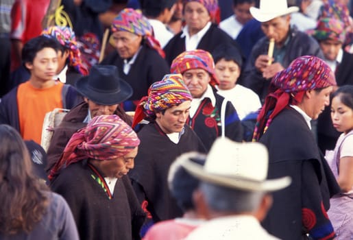 A relogion procession with people in traditional clotes at the Market in the Village of Chichi or Chichicastenango in Guatemala in central America.