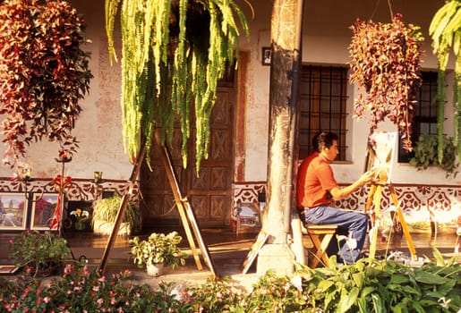 a painter in the old town in the city of Antigua in Guatemala in central America.