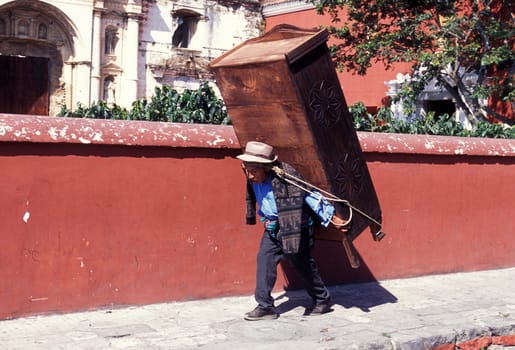 a men works in the old town in the city of Antigua in Guatemala in central America.