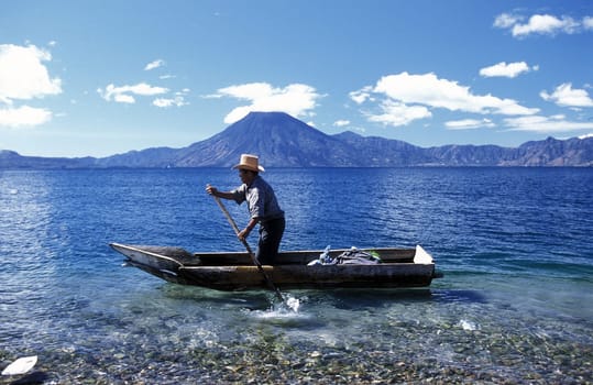 The Lake Atitlan with the Volcanos of Toliman and San Pedro in the back at the Town of Panajachel in Guatemala in Central America.