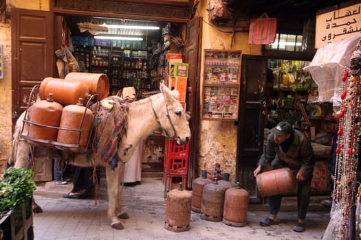 a smal Marketroad in the Medina of old City in the historical town of Fes in Morocco in north Africa.